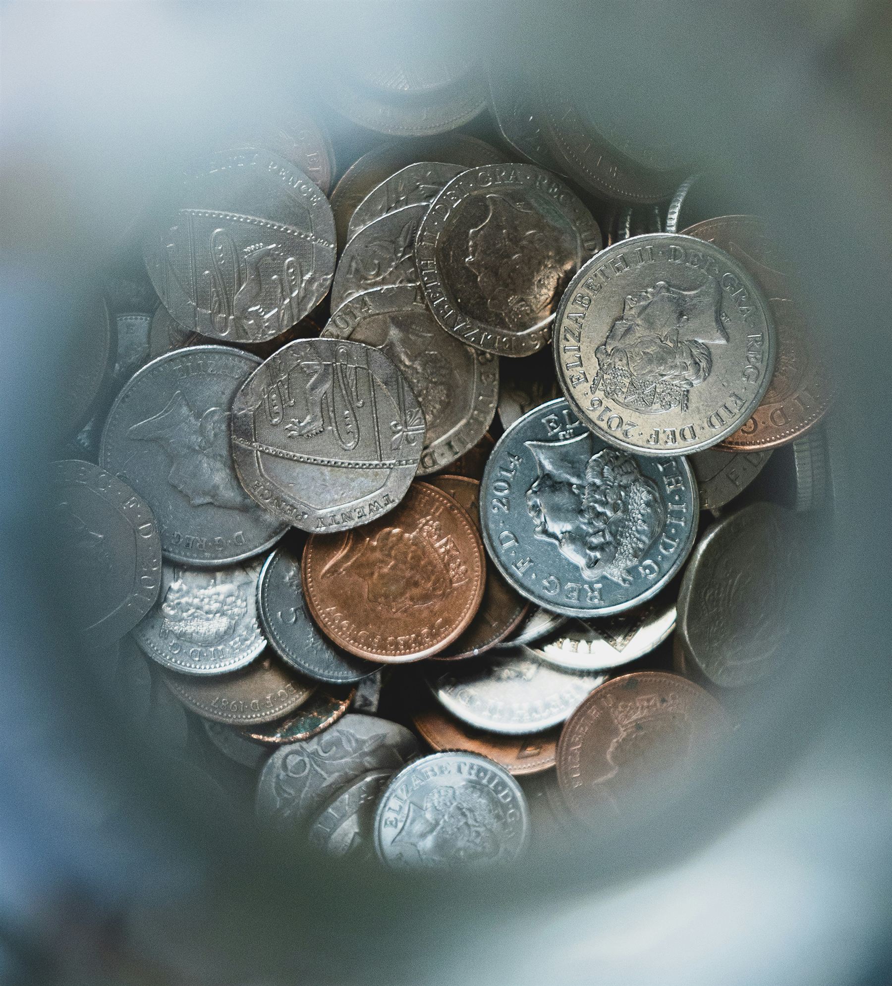 A close overhead view of a jumble of British coins.