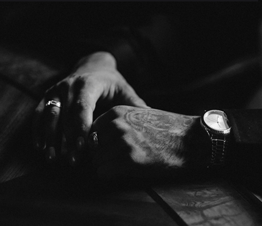A close-up of a hand, representing physical and psychological abuse.