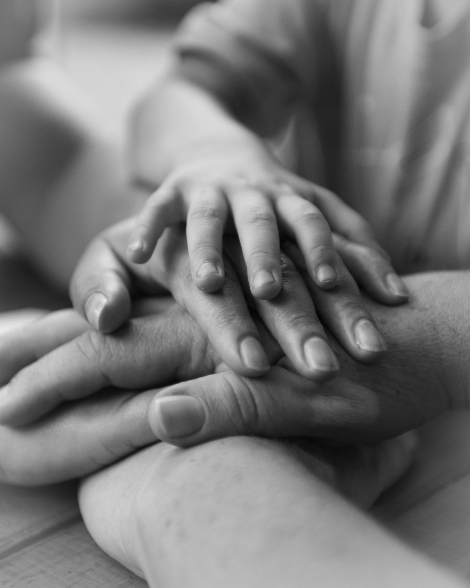 Hands resting together in a gesture of support.
